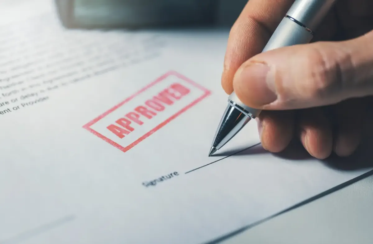 A document marked Approved being signed