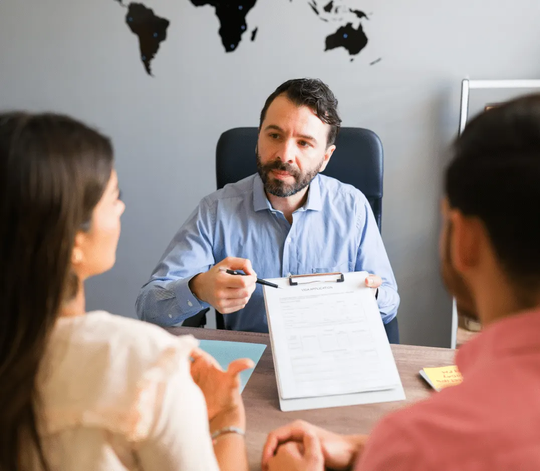 A consultant going through paperwork with two clients