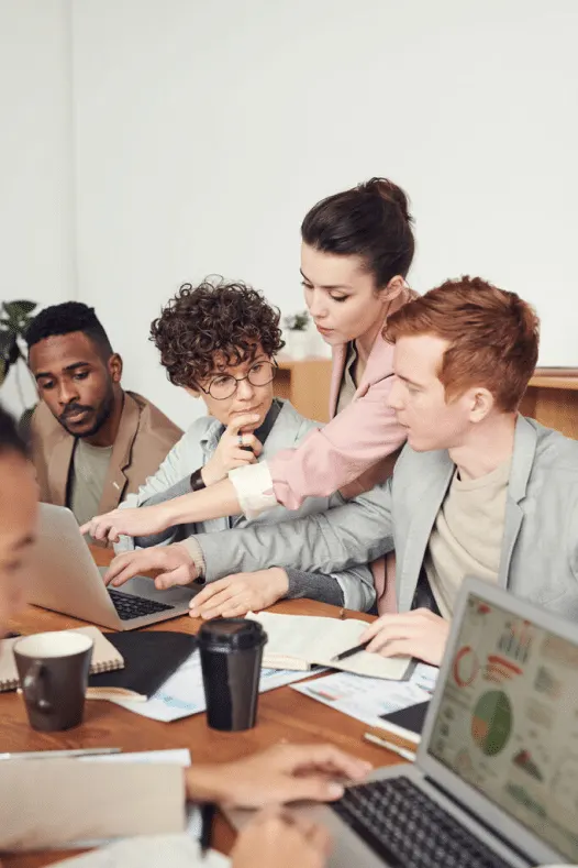 A team of skilled professionals working together at laptops