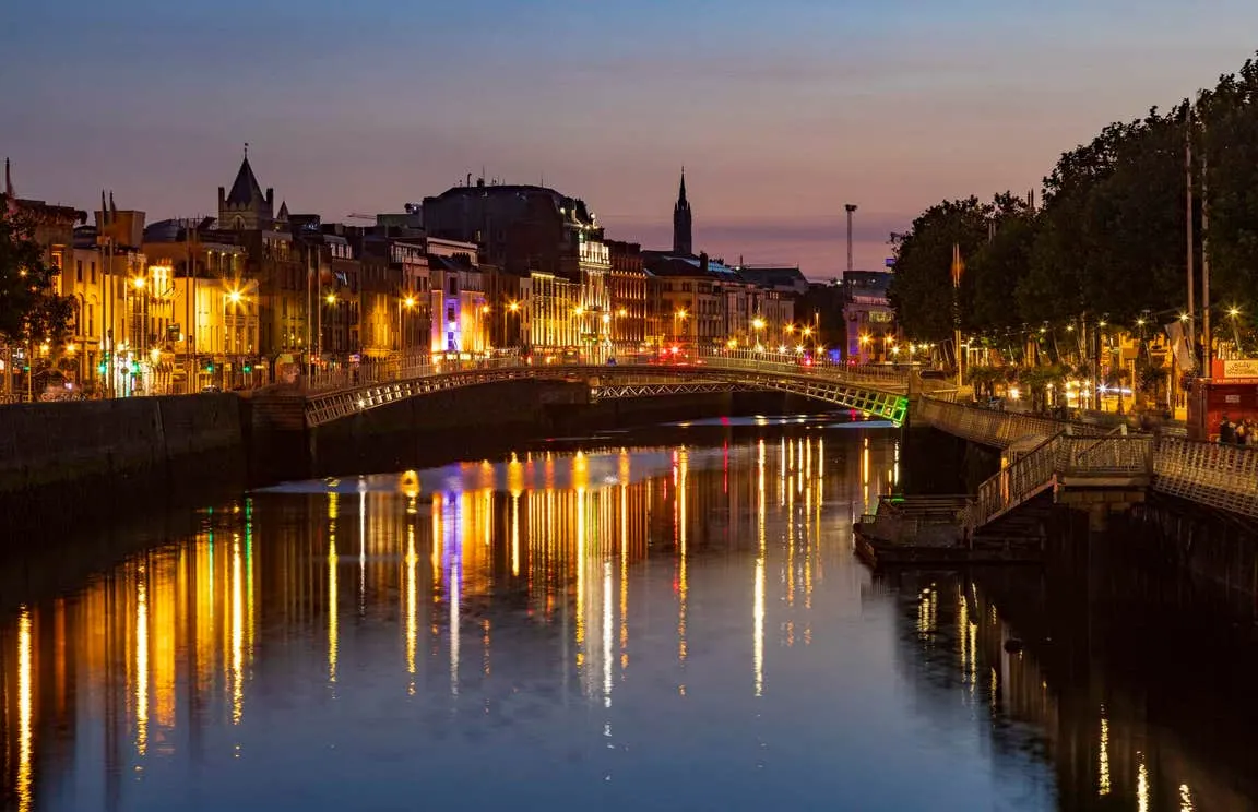 Dublin's quays and the Ha'penny Bridge lit up at dusk
